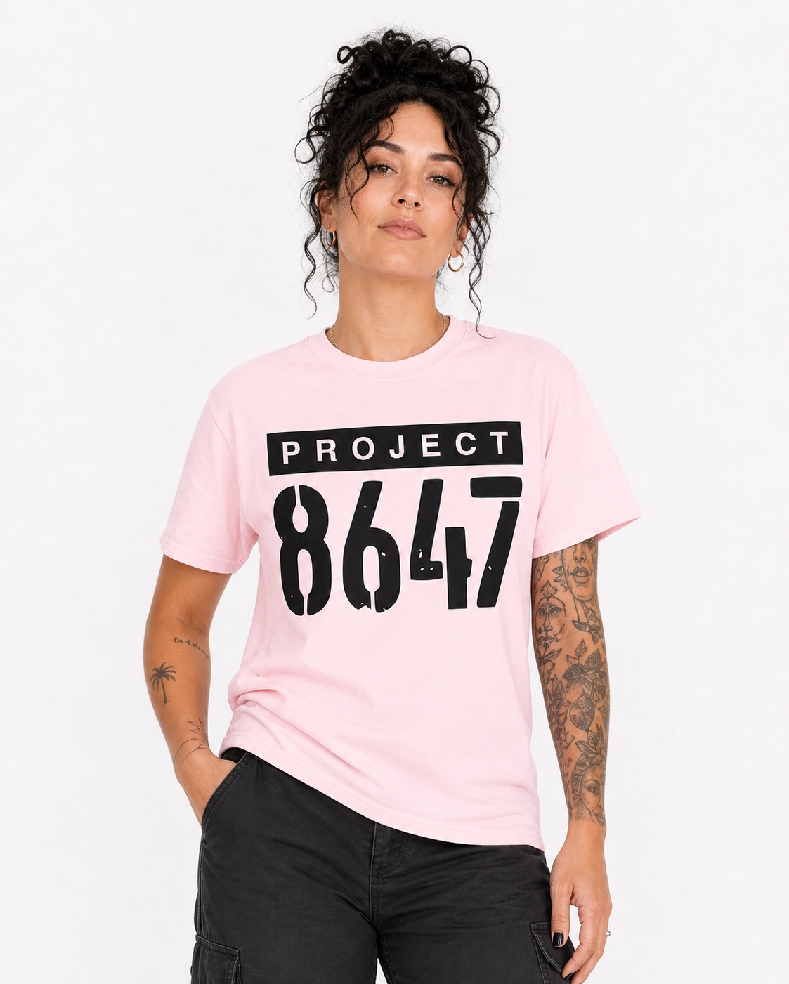 Woman wearing the light pink Project 8647 full-lockup T-shirt